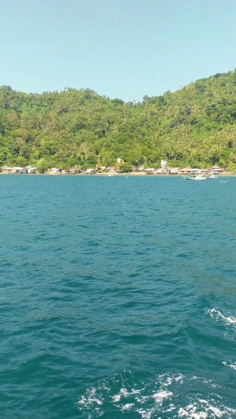 Beach on Lemukutan Island with a mountain backdrop Stock Footage 312661687