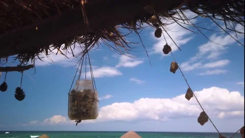 Beach Life Decorations with Sea Shells on Straw Roof of the Bar with Clear, 4K Stock-Footage 137970756