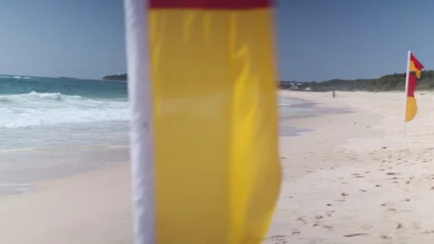Beach with Lifeguard Flags CU (pan) 002 Video stock 170344432