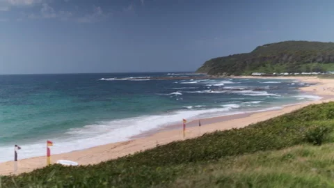 Beach with Lifeguard Flags WS (pan) 009 Video stock 170344348