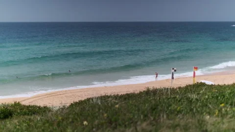 Beach with Lifeguard Flags WS (pan) 008 Video stock 170344375