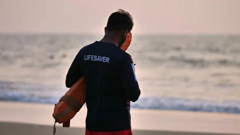 Beach lifeguard keeps order in the ocean Stock Footage 259719697