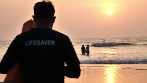 Beach lifeguard keeps order in the ocean Video stock 259719985
