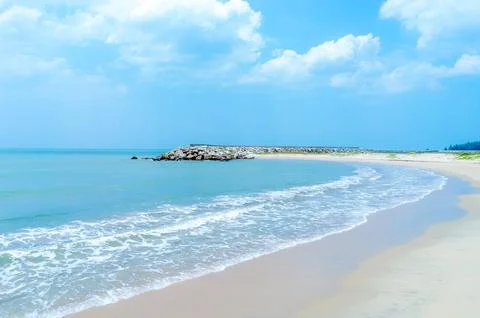 Beach is a long stretch with waves. Stock Photos