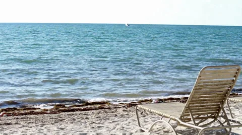 Beach lounge chair on an empty beach in the Florida Keys 스톡 동영상 32597167