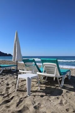 Beach lounge chairs Stock Photos