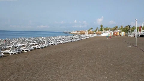 Beach loungers on an empty beach Stock Footage 92912081