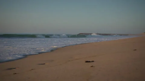 Beach low angle wide shot of the sea sunset hour Video stock 252559620