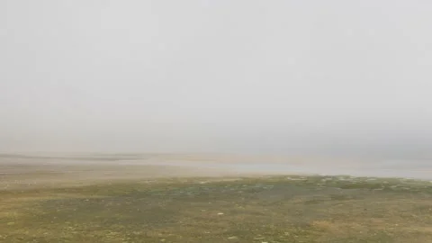 Beach with the low tide being covered by fog or mist, in Galicia, Spain Stock Footage 136260836