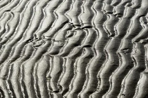 Beach at low tide with wave-like pattern, current ripples, North Sea, Norderney Stock Photos