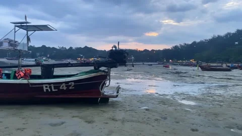 The beach at low tide on which there are many wooden boats. Stock Footage 231200563