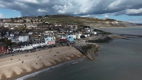 Beach Lyme Regis Devon UK dramatic sky background drone aerial view Stock Footage 333640218