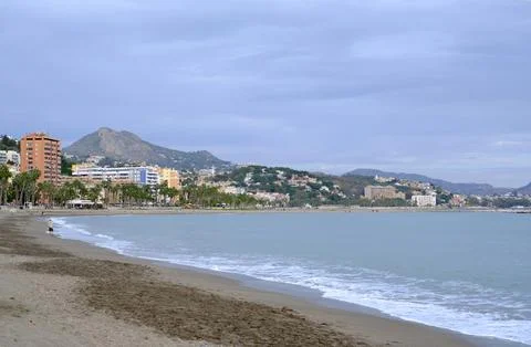 A beach of Malaga with a cloudy sky in the background. Stock Photos