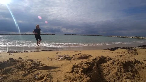 By the beach with a man running along, time lapse Stock Footage 183990243