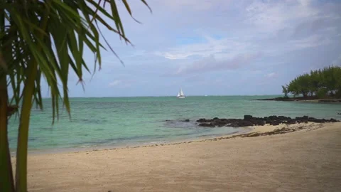 Beach on Mauritius island, ocean view and sailboat sailing by Stock Footage 178481997