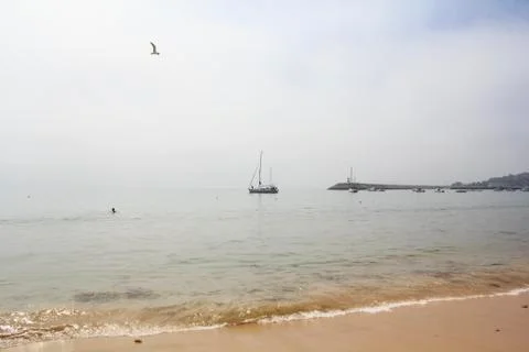 Beach in a misty day Stock Photos