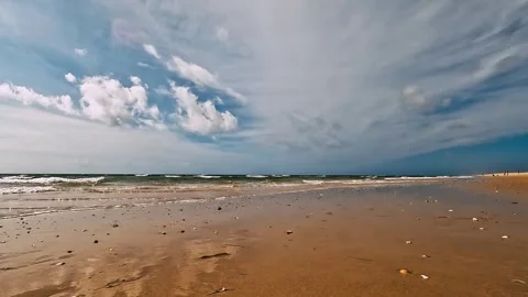 Beach in the morning with sky full of clouds Stock Footage 252593456