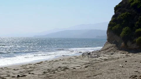 A beach with a mountain in the background Stock Footage 155581601