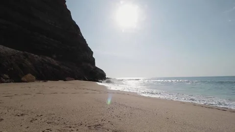 A beach with a mountain in the background Stock Footage 155583544