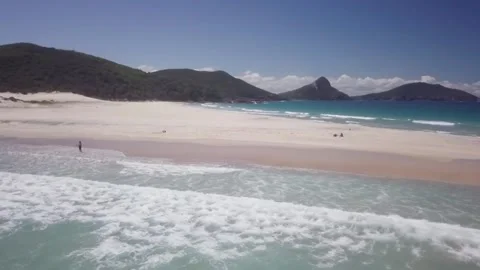 A beach with a mountain in the background Stock Footage 156334648