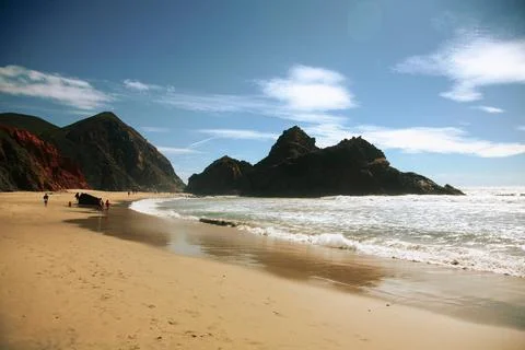 A beach with a mountain in the background Stock Photos