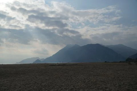 Beach with mountains in the background and clouds in Cirali Stock Photos