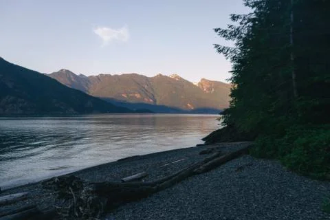Beach with mountains while sunset Stock Photos
