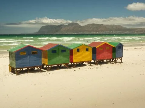 The beach of Muizenberg with its tiny colored huts Stock Photos
