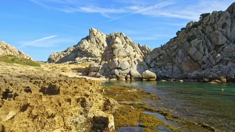 Beach nestled between huge rocks Stock Footage 128840549