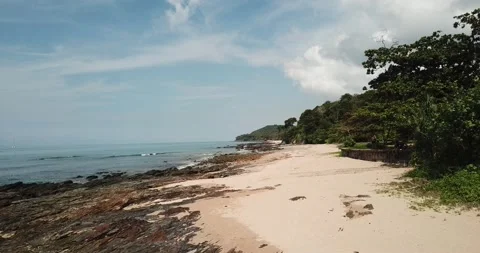 Beach next to the forest in Thailand, the waves lapping the sandy beach Stock Footage 149376548