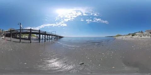 Beach next to pier with the waves coming in and out - 360 VR Video stock 90440888