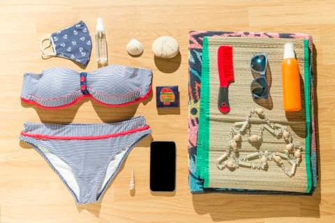 Beach objects and face mask on parquet flooring. Stock Photos