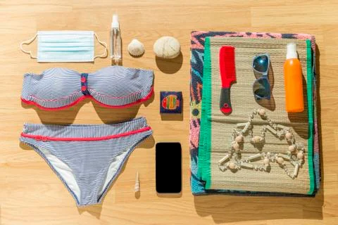Beach objects and face mask on parquet flooring. Stock Photos