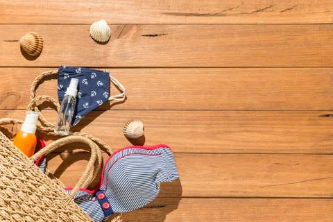 Beach objects, face mask and hydro alcoholic gel on wooden boards. Stock Photos