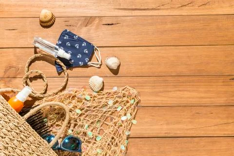 Beach objects, face mask and hydro alcoholic gel on wooden boards. Stock Photos