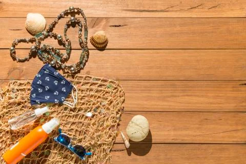 Beach objects, face mask and hydro alcoholic gel on wooden boards. Stock Photos