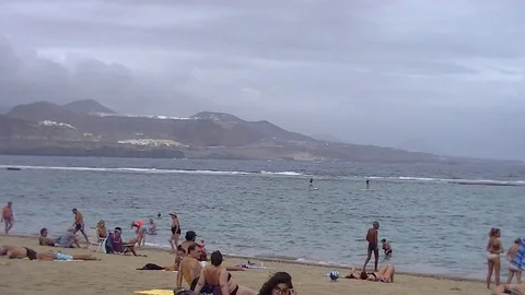 Beach, ocean and mountains in a cloudy day Stockbeeldmateriaal 80041881
