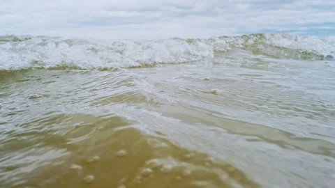 Beach ocean sea waves low angle,  Low angle of waves breaking the sand beach. Stock Footage 252600592