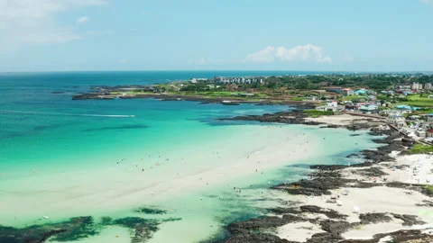 A beach overlooking the horizon and sky of the clear blue sea. drone view. Jeju  Stock Footage 203878286