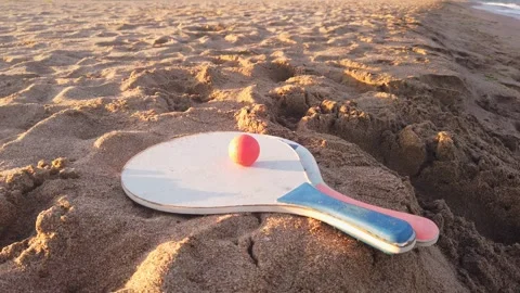 Beach Paddle Ball Set on Sand Top View at Sunset, Summer Scene 4K Stock Footage 331153472