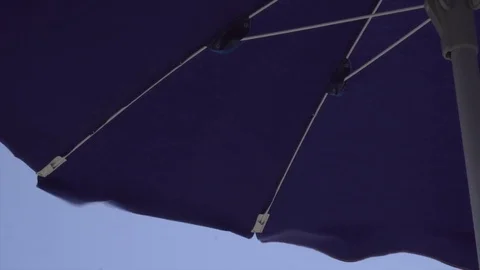 Beach parasol moving in the wind (4k) Video stock 79037699