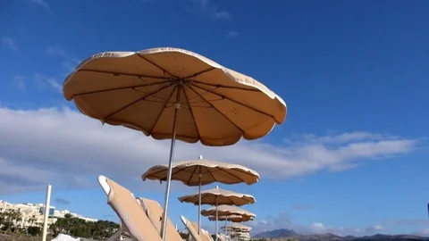 Beach parasol at wind Stock Footage 76343884
