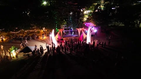 Beach party with dancing and illuminations in the evening. Top view. Drone video Stock Footage 297544480