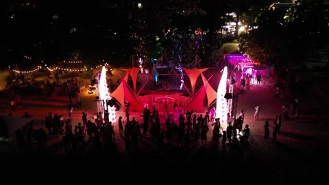 Beach party with dancing and illuminations in the evening. Top view. Drone video Stock Footage 297544483