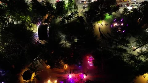 Beach party with dancing and illuminations in the evening. Top view. Drone video Stock Footage 297544490