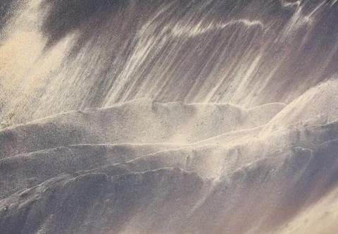 Beach pattern by waves on sand Stock Photos