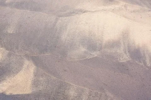 Beach pattern by waves on sand Stock Photos
