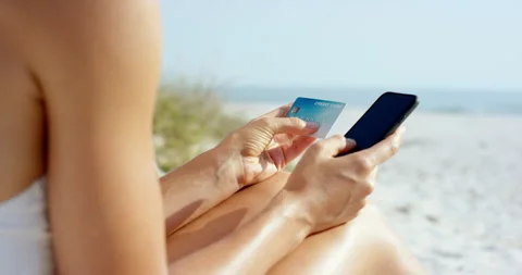 Beach, payment and hands with phone, credit card and online shopping with Stock Footage 334051331