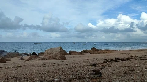 Beach with pebbles, big rocks and boats Stock Footage 276363345