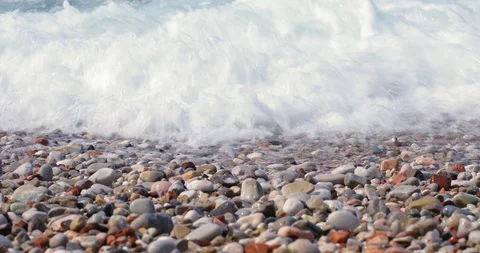 Beach pebbles on shore and rolling turquoise sea waves splashing Stock Footage 116470275